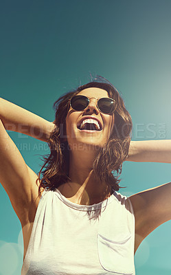 Buy stock photo Shot of an attractive young woman enjoying a day on the beach