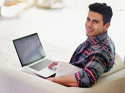 Buy stock photo Man, portrait and laptop on sofa for internet connection or entertainment subscription, writing or networking. Male person, face and smile on couch in living room with email, website or apartment