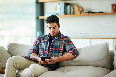 Buy stock photo Man, tablet and sofa for internet entertainment in home for streaming website, subscription or movie. Male person, couch and relax weekend in apartment for watching film in house, media or networking
