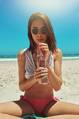 Buy stock photo Portrait of a sexy young woman enjoying a drink at the beach