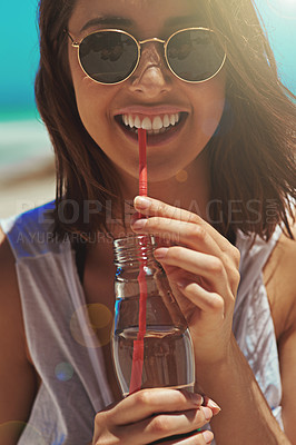 Buy stock photo Portrait of a sexy young woman enjoying a drink at the beach