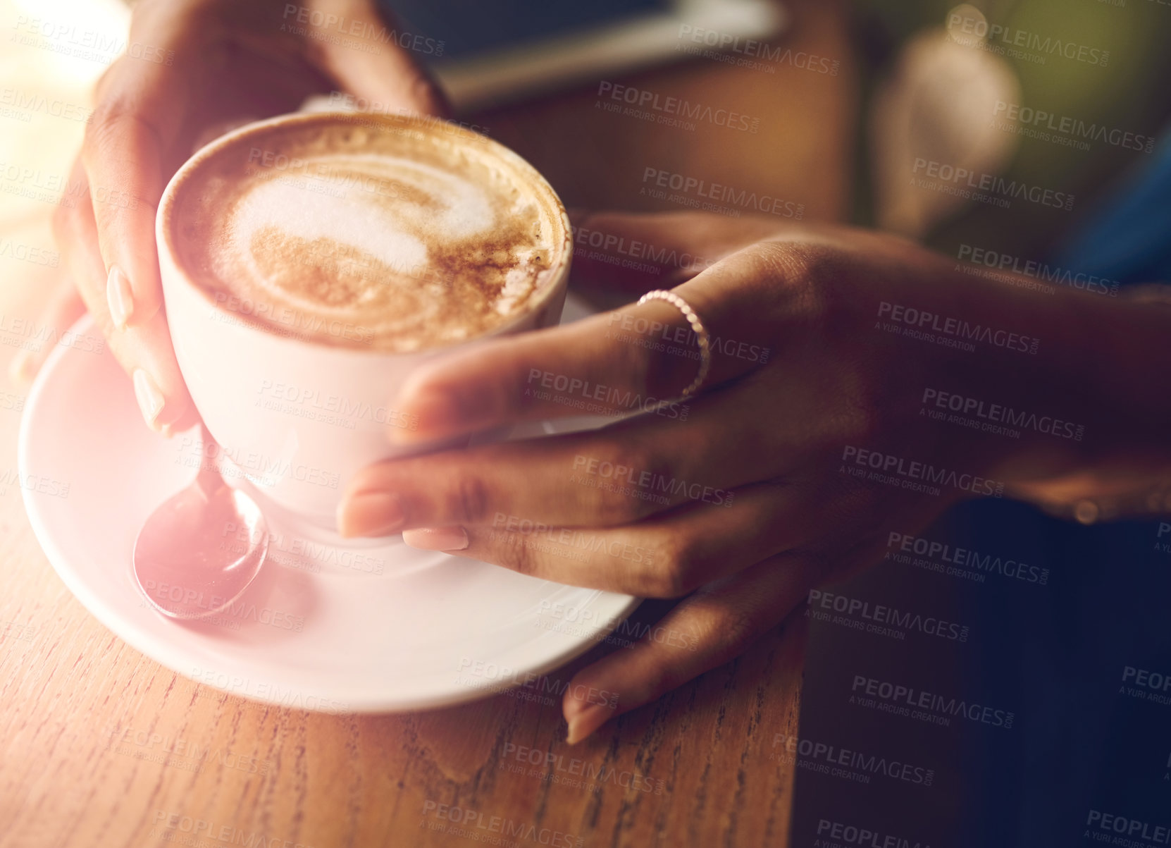 Buy stock photo Closeup shot of an unrecognizable woman having a cup of coffee at a cafe