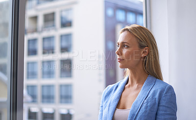 Buy stock photo Thinking, window and mockup with a business woman in the office, looking at a view of the city. Vision, future and idea with a corporate female employee standing at work planning company success