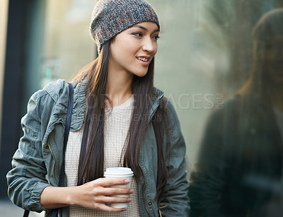 Buy stock photo Woman, fashion and window with city, coffee and urban street or background for style. Female student, beanie and jacket in cape town with winter, cold and travel with morning commute for confidence
