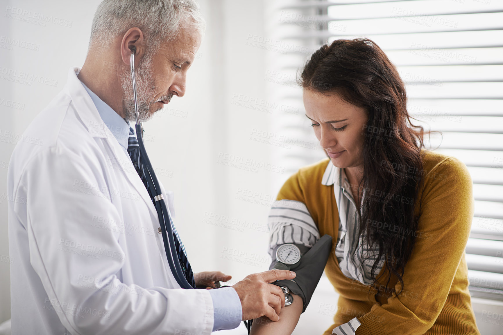 Buy stock photo Doctor, blood pressure and woman patient at clinic with hospital consultation for health insurance. Healthcare, stethoscope and check pulse for medical exam, wellness and hypertension diagnosis