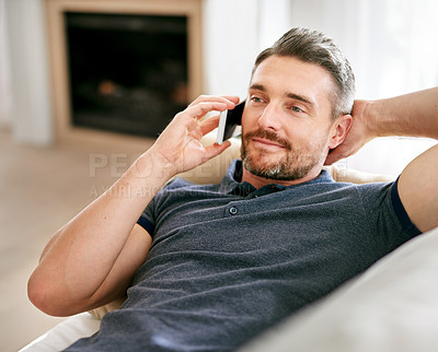 Buy stock photo Home, relax and phone call with man, communication and contact with technology and mobile user. Person on a couch, apartment and guy with cellphone and conversation with discussion, talk and speaking