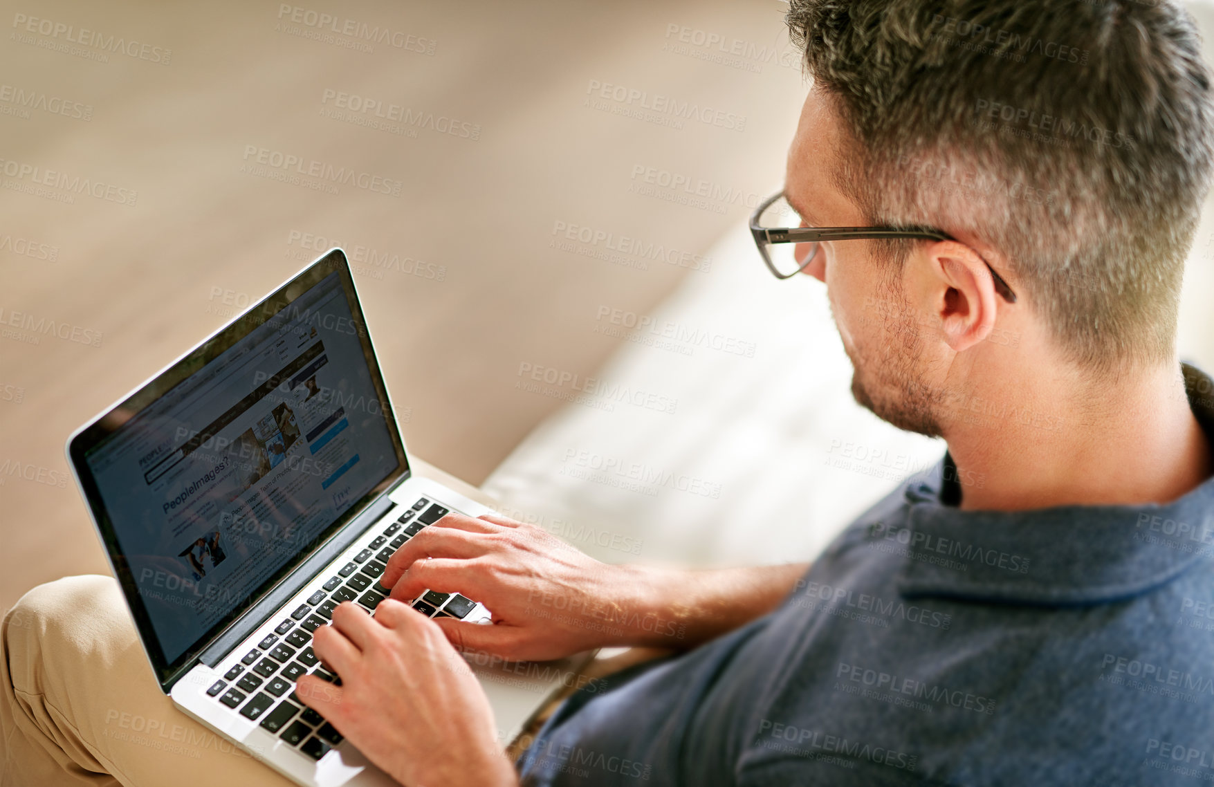 Buy stock photo Man, laptop and working from home for business, company or startup in living room. Male person, copywriter and employee in house with technology, UX and browsing for deadline, editor or manager