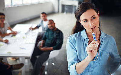 Buy stock photo Shot of a woman deep in thought while giving a whiteboard presentation to colleagues in an office