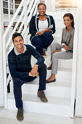 Buy stock photo Portrait of a group of coworkers sitting in a stairwell in a modern office