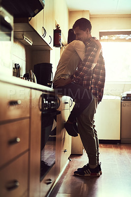Buy stock photo Shot of an affectionate young couple sharing a romantic moment in the kitchen