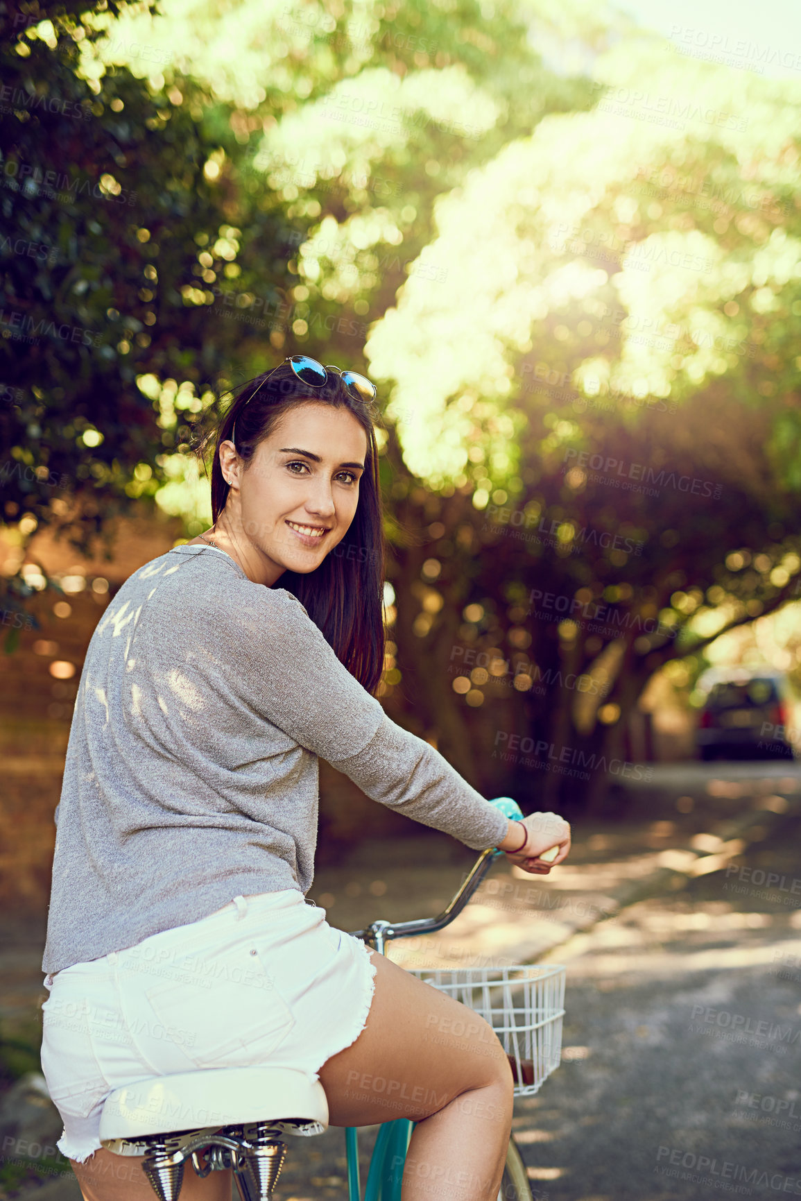 Buy stock photo Portrait of an attractive young woman riding her bicycle outside