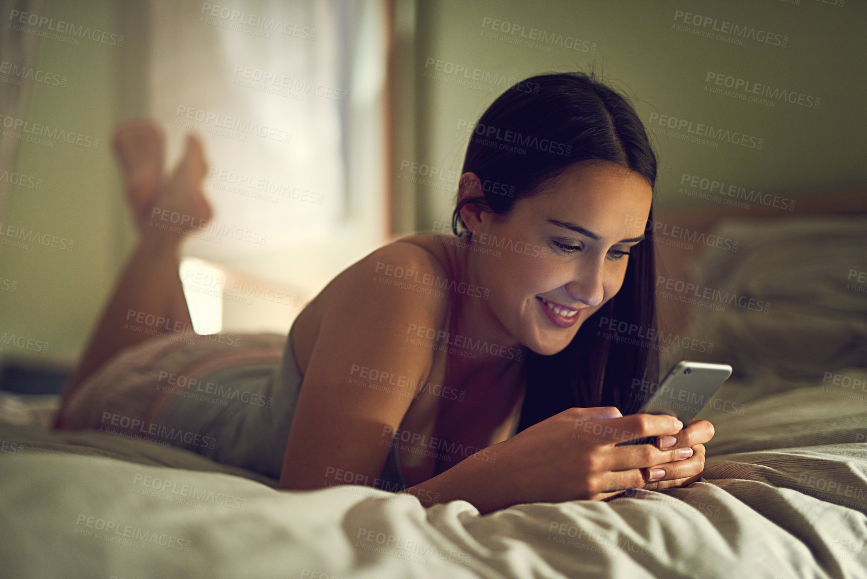 Buy stock photo Home, woman and cellphone in bedroom for social media, chat and networking online with contact. Tech, connection and happy girl with smartphone for text message, conversation and comfortable in bed