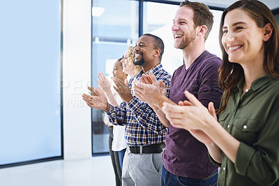 Buy stock photo Cropped shot of a team of designers applauding while standing in a row in an office