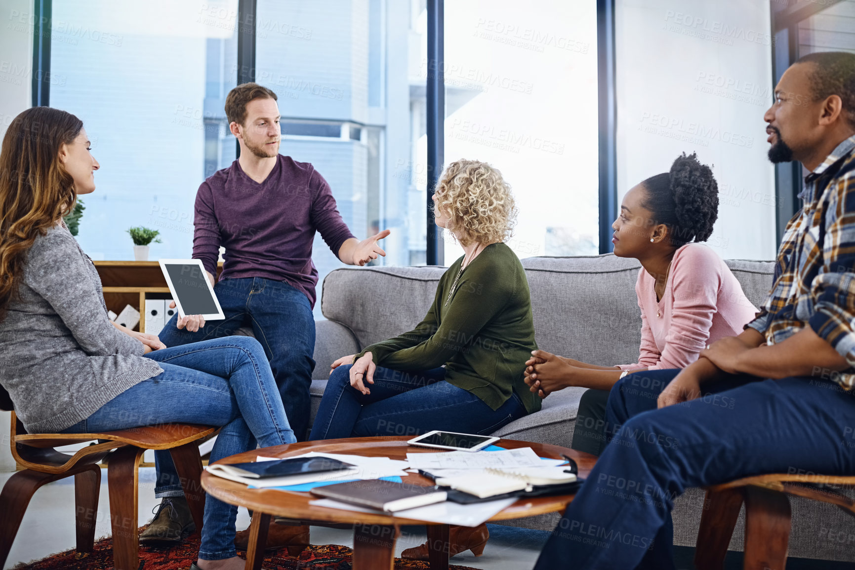 Buy stock photo Creative man, presentation and meeting with tablet for team discussion, planning or design at office. Group of employees listening to coach with technology in collaboration for startup at workplace