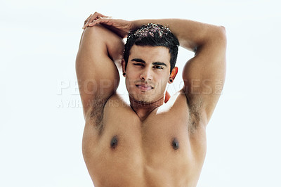 Buy stock photo Portrait of a shirtless young man stretching his arms outside