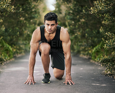 Buy stock photo Portrait of a focused young sportsman in the starting position before a run