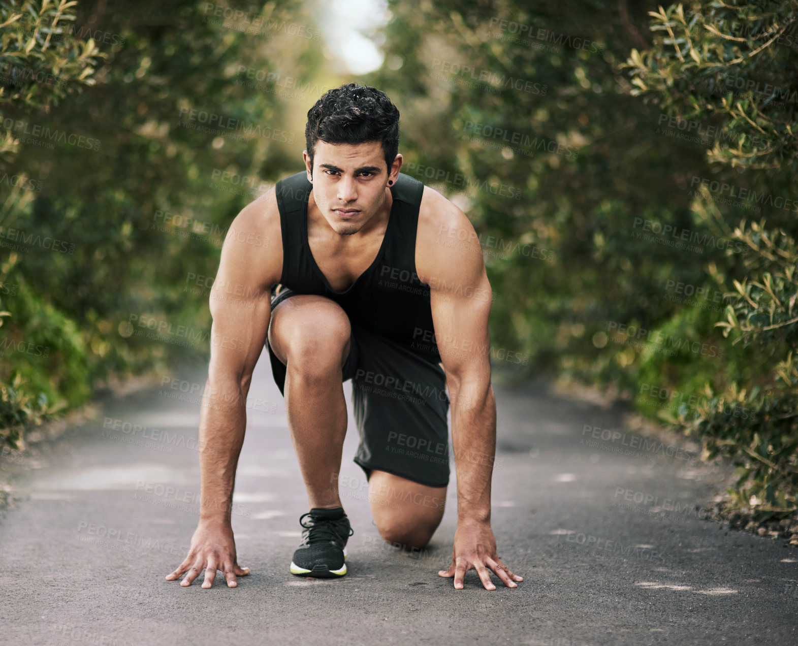 Buy stock photo Man, runner or start of running in park, nature or sidewalk for outdoor exercise, race or fitness training. Male person, guy or Indian athlete ready for marathon practice, sports or action in workout