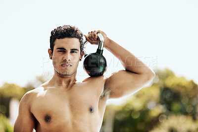 Buy stock photo Portrait of a shirtless young man posing with a kettle bell outside