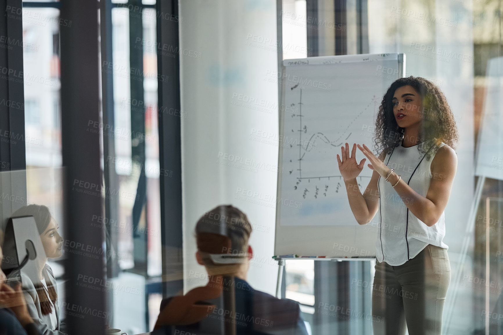 Buy stock photo Shot of a well dressed businesswoman giving a presentation to her colleagues in the boardroom