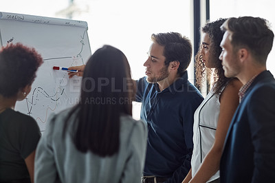 Buy stock photo Shot of a well dressed businessman giving a presentation to his colleagues in the boardroom