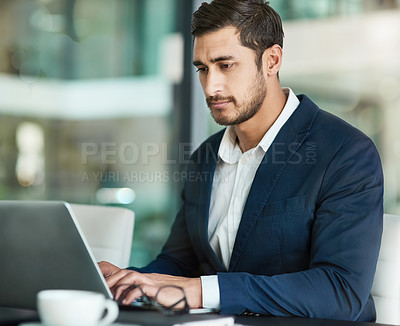 Buy stock photo Shot of a focused executive working on a laptop in an office