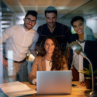 Buy stock photo Portrait of a group of businesspeople using a laptop while working overtime in the office