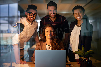 Buy stock photo Portrait of a group of businesspeople using a laptop while working overtime in the office
