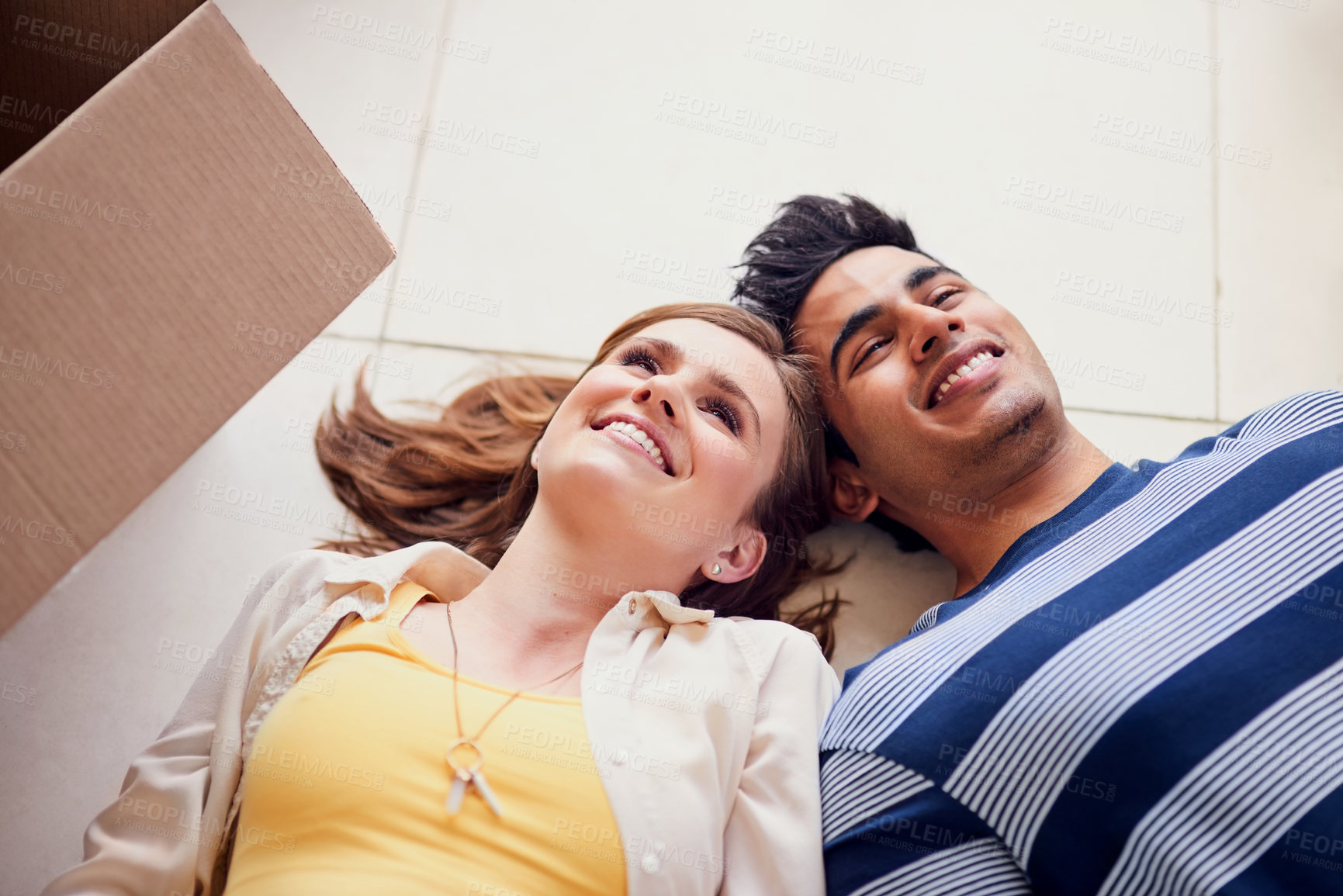 Buy stock photo Floor, moving house and smile with couple in new home for property or real estate investment. Box, face or smile with happy man and woman thinking of future or growth in apartment together from above