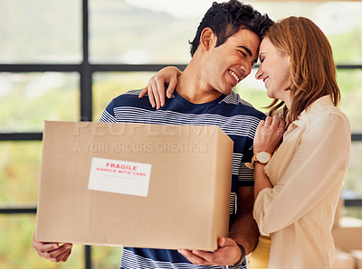 Buy stock photo Shot of a affectionate young couple carrying boxes on moving day