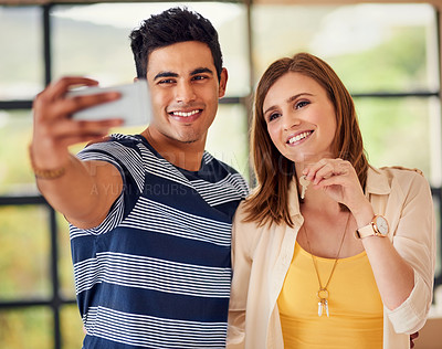 Buy stock photo Shot of a happy young couple taking a selfie together on their moving in day