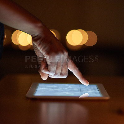 Buy stock photo Closeup shot of a person's finger using a digital tablet in the dark