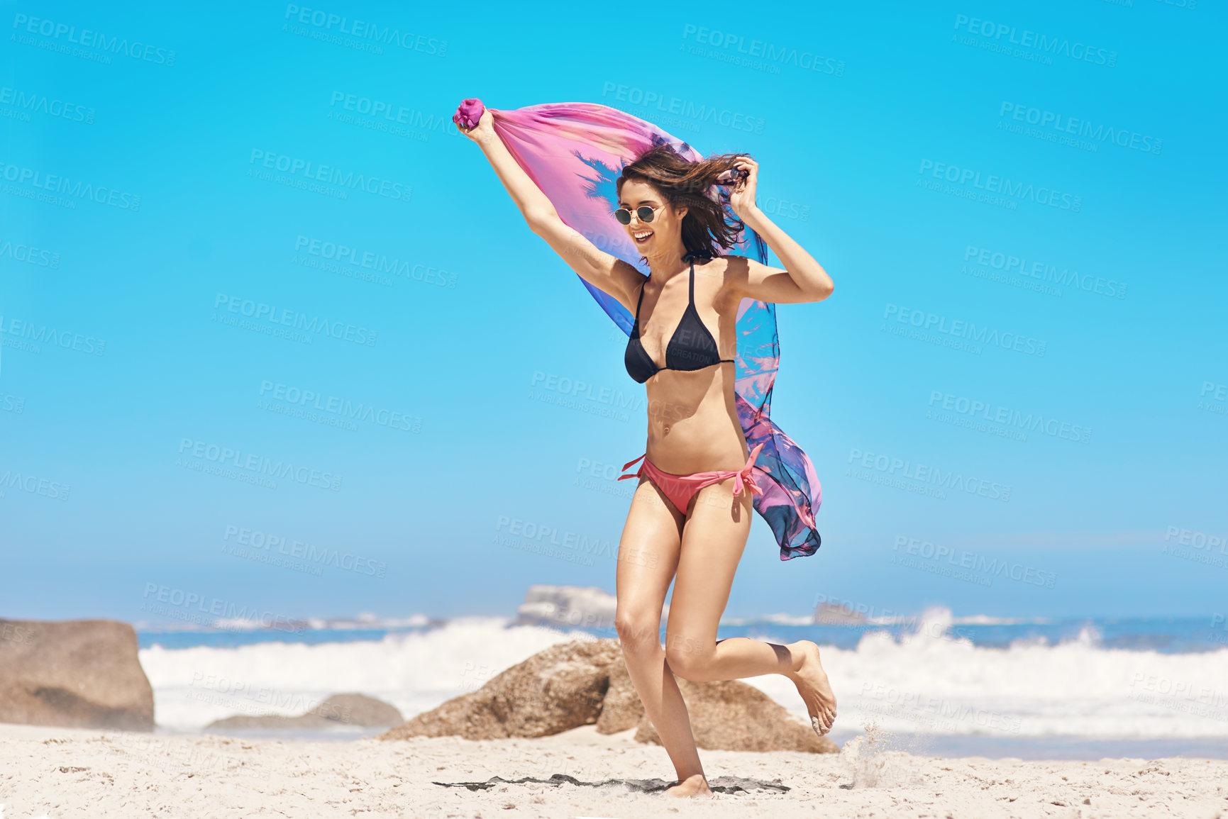 Buy stock photo Shot of a sexy young woman running on the beach