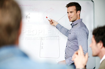 Buy stock photo Businessman, coach and presentation with whiteboard in meeting for staff training or planning at office. Young man, speaker or employee showing colleagues or team graph, chart or information on board