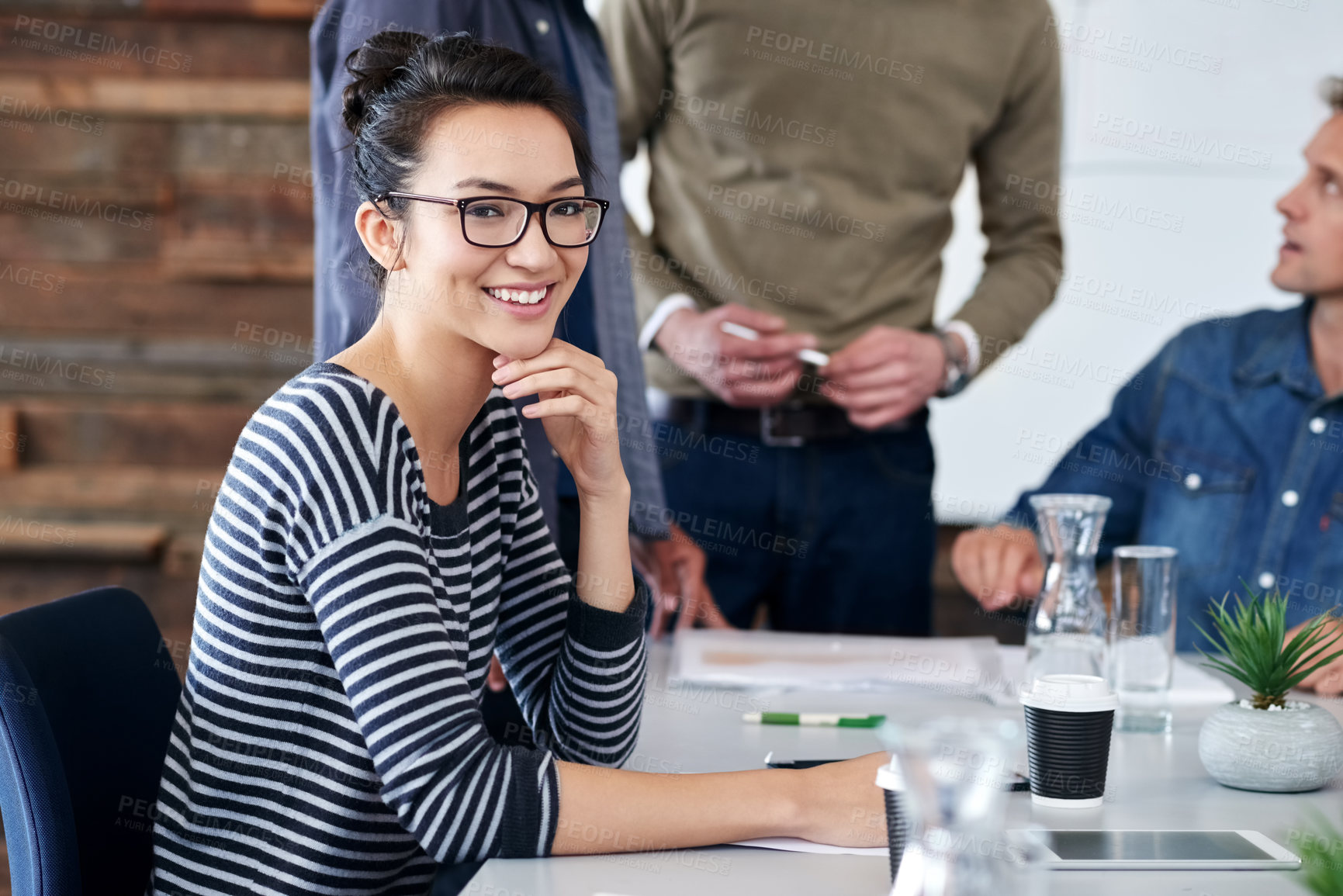 Buy stock photo Portrait, leader and woman with smile, desk and meeting with group, teamwork and planning for project. Design, agency and employee with happiness, creative and table for tablet, together and office