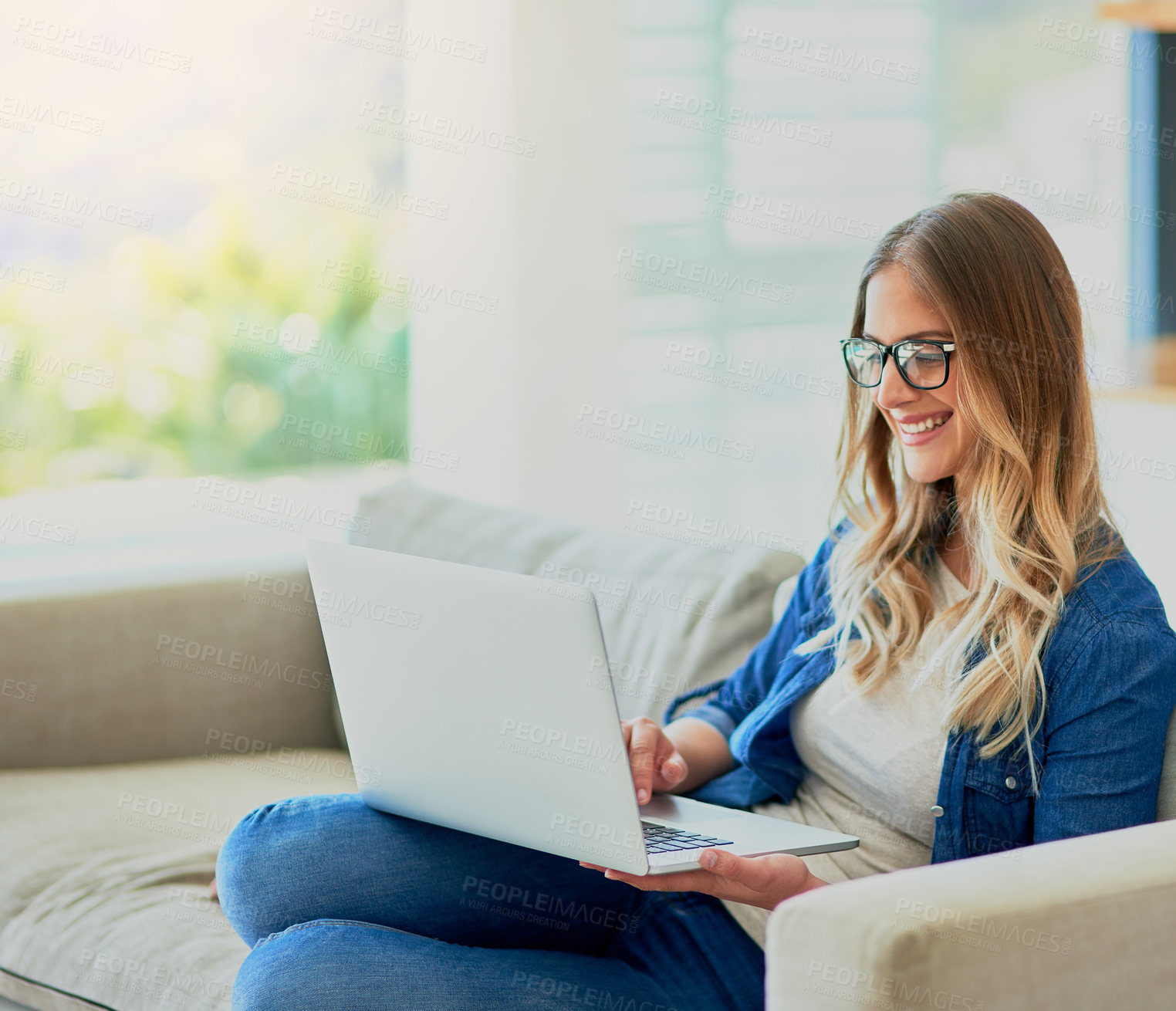 Buy stock photo Woman, happy and relax on sofa with laptop for online streaming entertainment, social media memes and comedy movie. Girl, home and technology with internet for reading articles or ebooks and websites