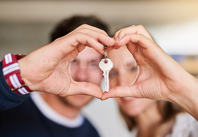 Buy stock photo Portrait of a happy young couple proudly displaying the keys to their new house