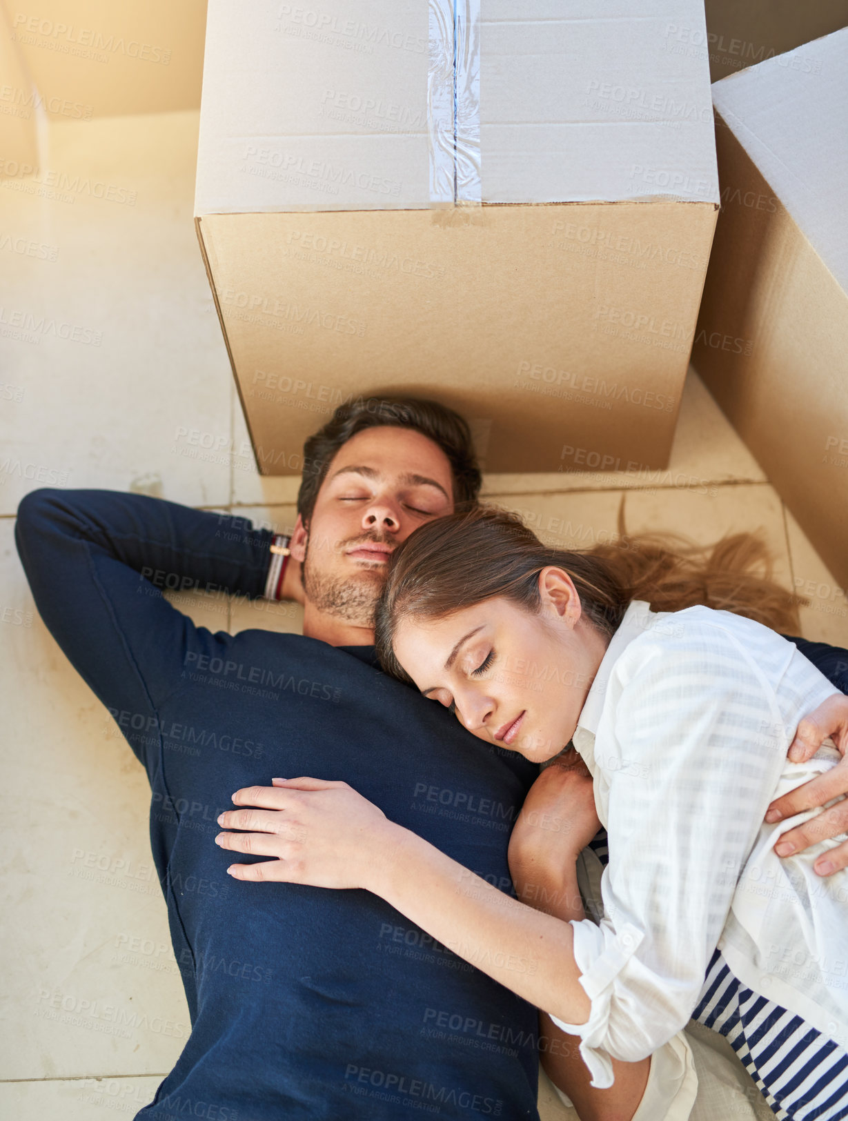 Buy stock photo Couple, sleeping and relax with box on floor for moving in new home, property or apartment above. Top view of tired man and woman asleep in relaxation for house investment, rest or break with boxes