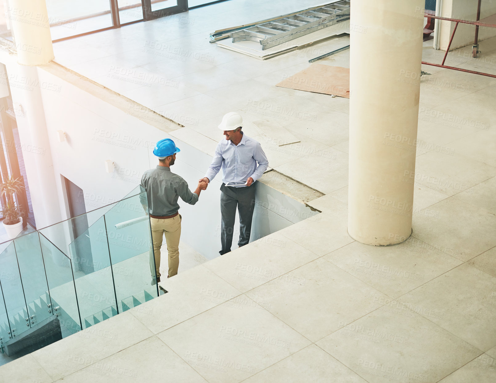 Buy stock photo Handshake, deal and architect in building with partnership for design or project success. Shaking hands, trust and engineer for contract by workplace site on stairs with collaboration or teamwork