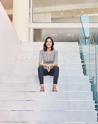 Buy stock photo Portrait of a confident young designer sitting on the steps in her office