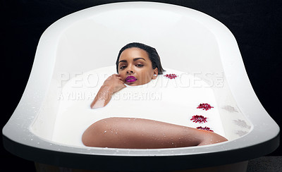 Buy stock photo Portrait of a beautiful young woman submerged in white liquid in a bathtub