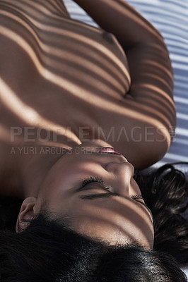 Buy stock photo Shot of a beautiful nude woman posing under a patterned shadow