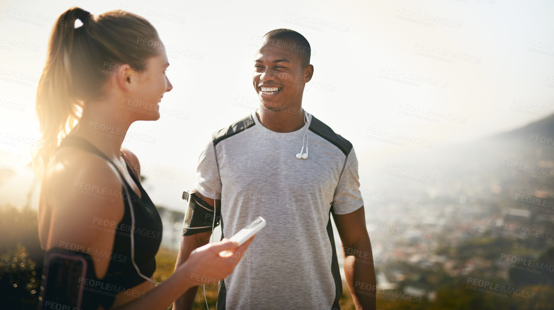 Buy stock photo Shot of a fit young couple working out together outdoors