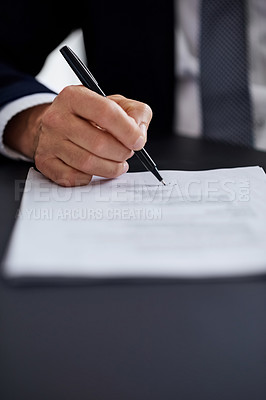 Buy stock photo Closeup shot of a businessman signing a contract while sitting at a desk in an office