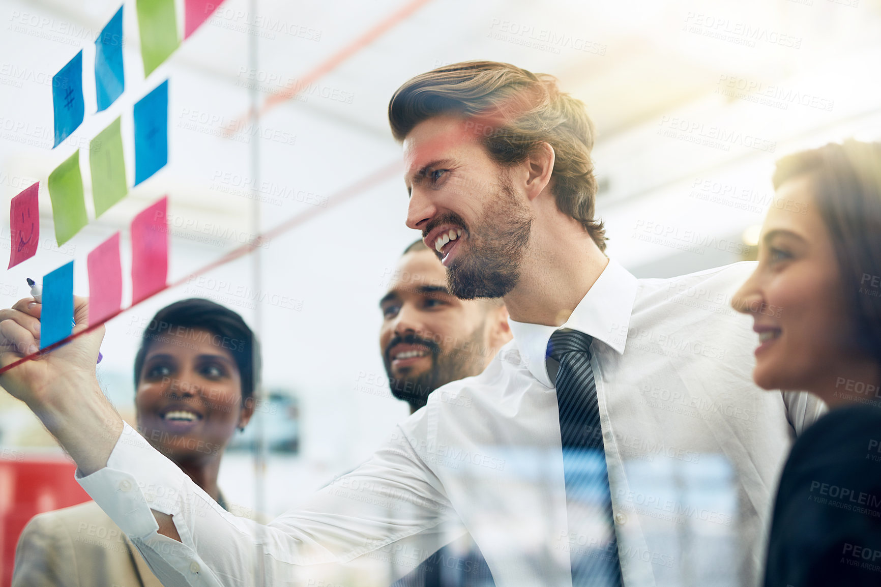 Buy stock photo Shot of colleagues brainstorming in the office