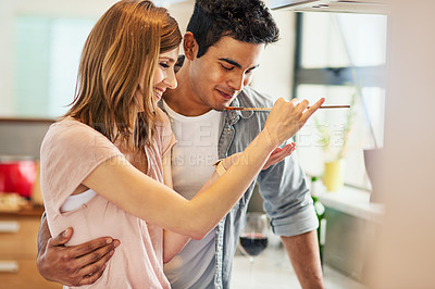 Buy stock photo Man, woman and spoon for cooking, together and eating with relationship and love in kitchen. Couple, home and food for play, diner or supper with romance and recipe for date and relaxation in house