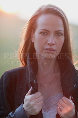 Buy stock photo Cropped portrait of an attractive woman posing outside