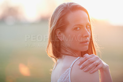 Buy stock photo Cropped portrait of an attractive woman posing outside