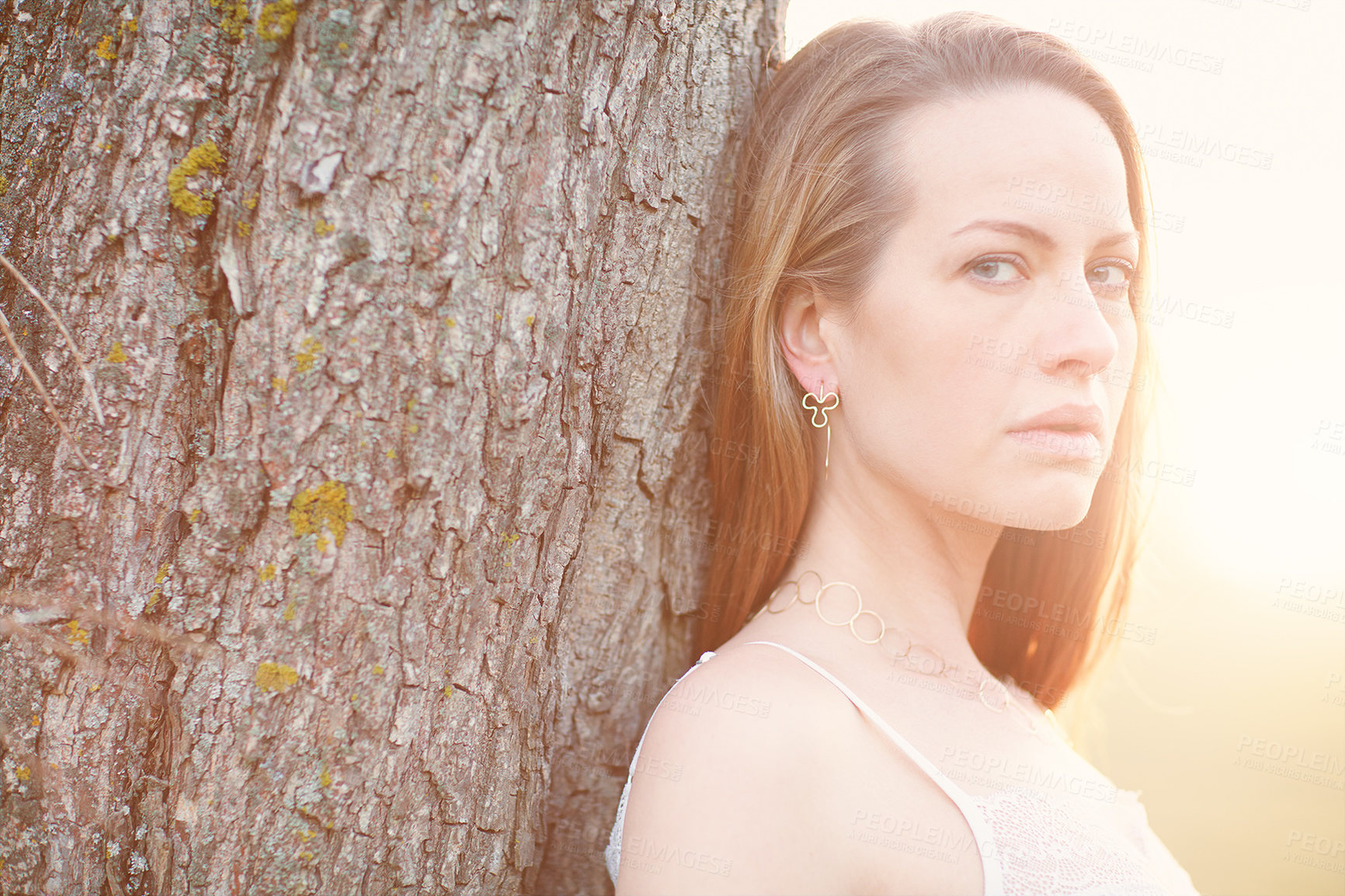 Buy stock photo Cropped portrait of an attractive woman posing outside