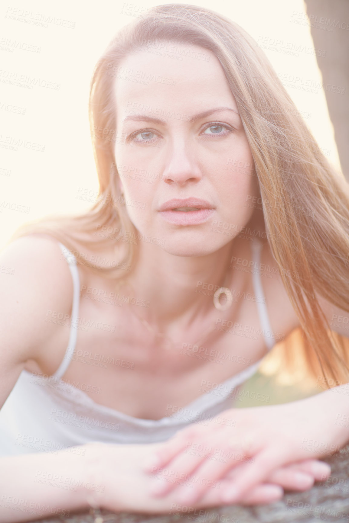 Buy stock photo Cropped portrait of an attractive woman posing outside