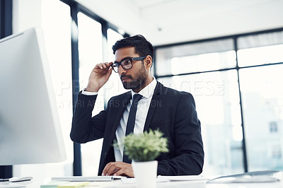 Buy stock photo Cropped shot of a young businessman working on his computer